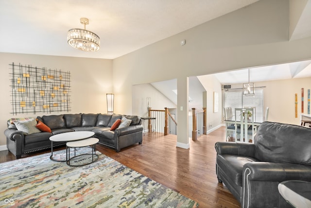 35 Osage Ct, Columbus, IN 47201 - living room with a chandelier, wood finished floors, baseboards, and vaulted ceiling