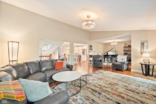 35 Osage Ct, Columbus, IN 47201 - living room featuring a chandelier, wood finished floors, lofted ceiling, and baseboards