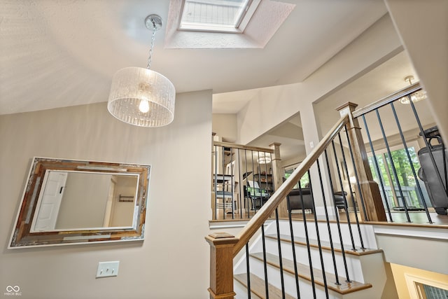 35 Osage Ct, Columbus, IN 47201 - staircase featuring a skylight and lofted ceiling