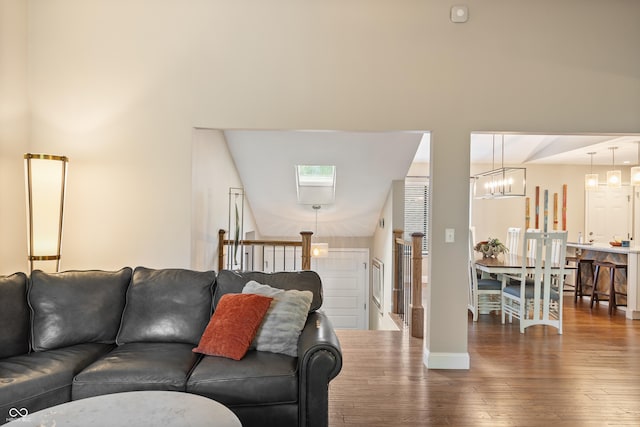 35 Osage Ct, Columbus, IN 47201 - living room with hardwood / wood-style flooring, baseboards, and a chandelier