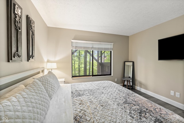 35 Osage Ct, Columbus, IN 47201 - bedroom with dark wood-style flooring, baseboards, and a textured ceiling