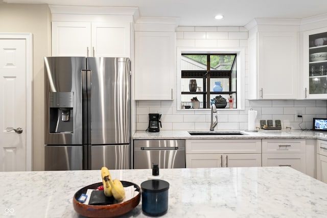 35 Osage Ct, Columbus, IN 47201 - kitchen featuring appliances with stainless steel finishes, a sink, glass insert cabinets, decorative backsplash, and white cabinetry