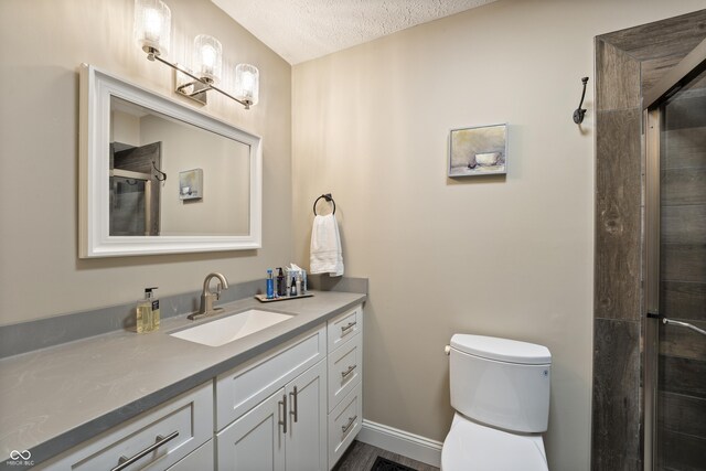 35 Osage Ct, Columbus, IN 47201 - full bathroom with vanity, toilet, a textured ceiling, and a tile shower