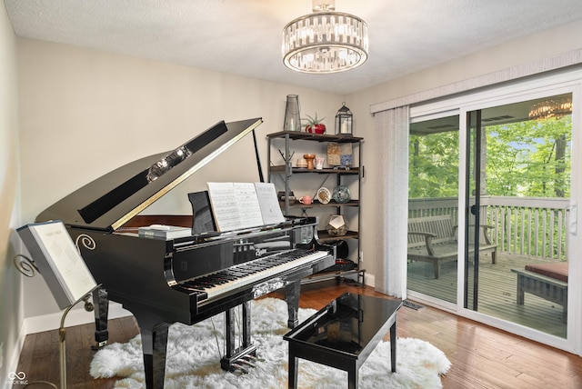 35 Osage Ct, Columbus, IN 47201 - sitting room featuring wood finished floors, a chandelier, and a textured ceiling