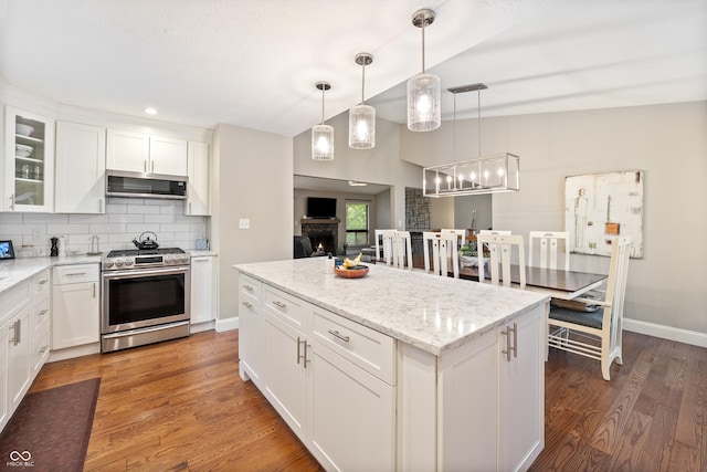 35 Osage Ct, Columbus, IN 47201 - kitchen with stainless steel appliances, tasteful backsplash, white cabinetry, glass insert cabinets, and light wood-type flooring