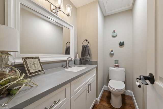 35 Osage Ct, Columbus, IN 47201 - half bathroom with vanity, toilet, wood finished floors, and baseboards