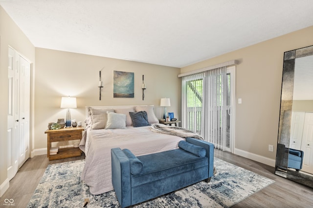35 Osage Ct, Columbus, IN 47201 - bedroom featuring wood finished floors, access to exterior, and baseboards