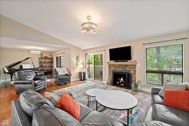 35 Osage Ct, Columbus, IN 47201 - living room with a chandelier, a stone fireplace, baseboards, wood finished floors, and lofted ceiling