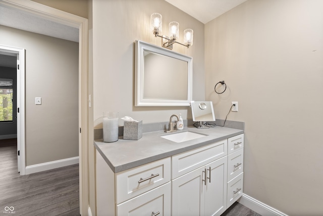 35 Osage Ct, Columbus, IN 47201 - bathroom featuring baseboards, vanity, and wood finished floors