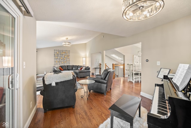 35 Osage Ct, Columbus, IN 47201 - living area featuring a chandelier, wood finished floors, vaulted ceiling, and baseboards