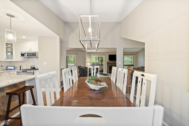 35 Osage Ct, Columbus, IN 47201 - dining room with baseboards, wood finished floors, and a chandelier
