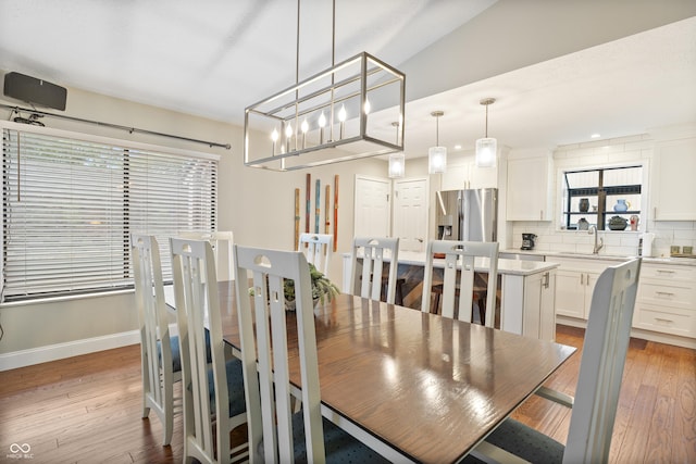 35 Osage Ct, Columbus, IN 47201 - dining space with light wood-type flooring, baseboards, and a chandelier