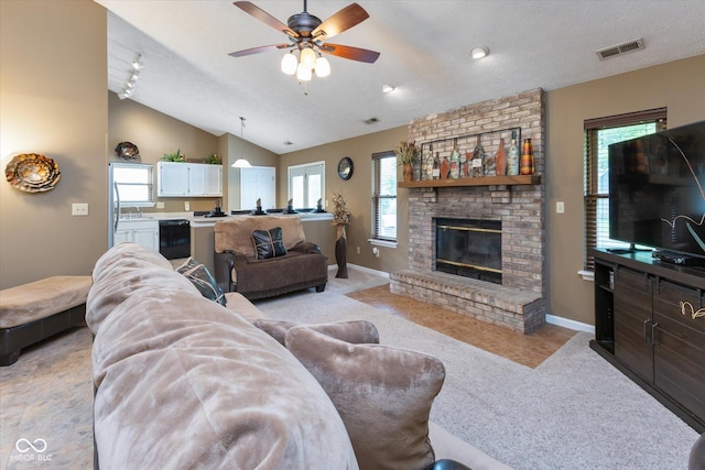 3630 Foxtail Dr, Indianapolis, IN 46235 - living area featuring light carpet, a ceiling fan, a fireplace, baseboards, and vaulted ceiling