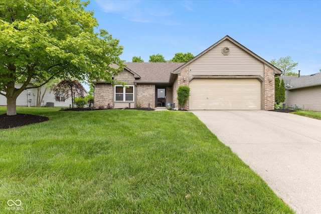 3630 Foxtail Dr, Indianapolis, IN 46235 - single story home featuring brick siding, a garage, driveway, a front lawn, and roof with shingles