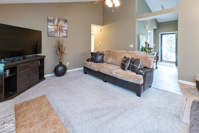 3630 Foxtail Dr, Indianapolis, IN 46235 - living room featuring ceiling fan, carpet floors, high vaulted ceiling, baseboards, and tile patterned flooring