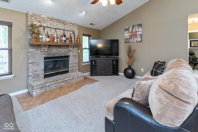 3630 Foxtail Dr, Indianapolis, IN 46235 - living area with a ceiling fan, carpet, lofted ceiling, a brick fireplace, and baseboards