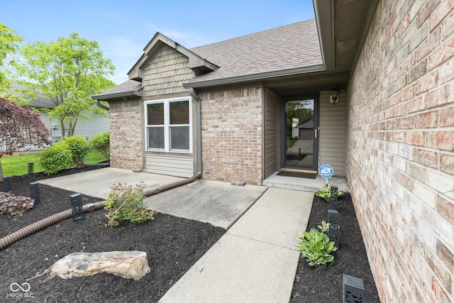 3630 Foxtail Dr, Indianapolis, IN 46235 - property entrance featuring brick siding, a shingled roof, and a patio
