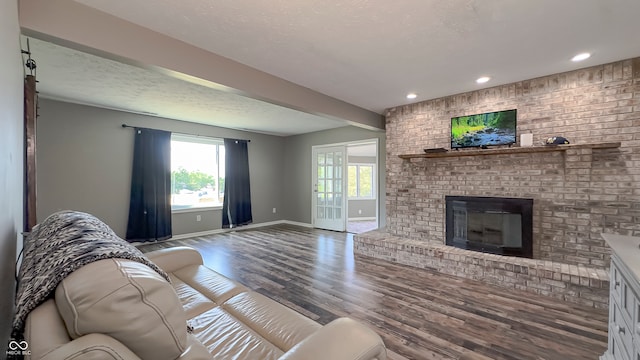 80 E College Ave, Martinsville, IN 46151 - living area featuring wood finished floors, baseboards, a brick fireplace, recessed lighting, and a textured ceiling
