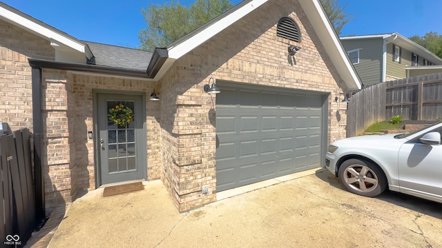 80 E College Ave, Martinsville, IN 46151 - entrance to property with concrete driveway, brick siding, an attached garage, and fence