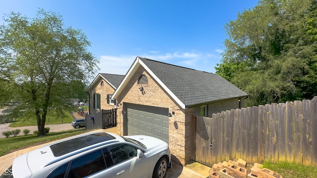 80 E College Ave, Martinsville, IN 46151 - view of side of home with brick siding, fence, a garage, and a shingled roof