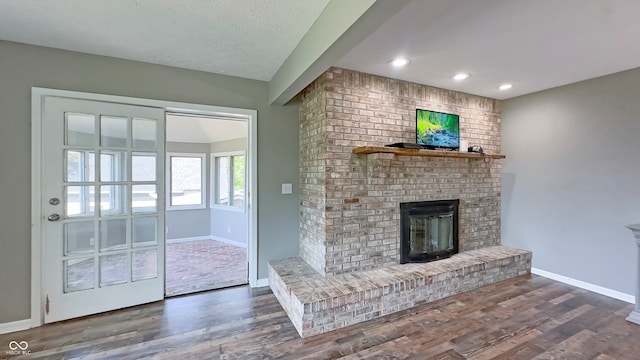 80 E College Ave, Martinsville, IN 46151 - unfurnished living room featuring a fireplace, baseboards, wood finished floors, and recessed lighting