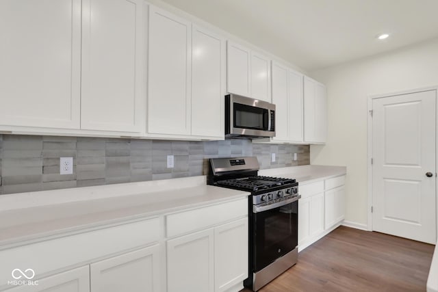 104 Maxim Ct, Cumberland, IN 46229 - kitchen with appliances with stainless steel finishes, light countertops, white cabinetry, and recessed lighting