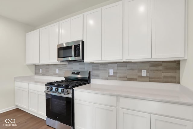 104 Maxim Ct, Cumberland, IN 46229 - kitchen featuring stainless steel appliances, light countertops, and white cabinets