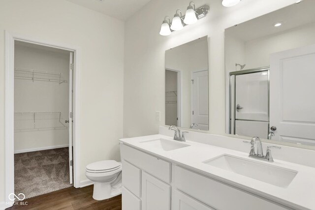 104 Maxim Ct, Cumberland, IN 46229 - full bathroom with a stall shower, a spacious closet, toilet, and double vanity