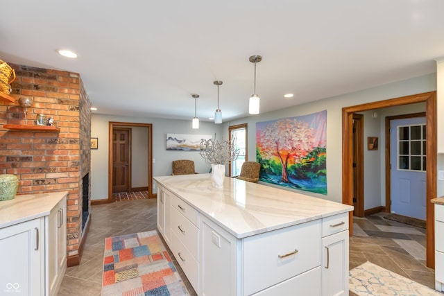 1541 Stadium Dr, Seymour, IN 47274 - kitchen with recessed lighting, white cabinets, baseboards, hanging light fixtures, and light stone countertops