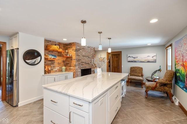 1541 Stadium Dr, Seymour, IN 47274 - kitchen featuring freestanding refrigerator, baseboards, light stone countertops, recessed lighting, and a fireplace