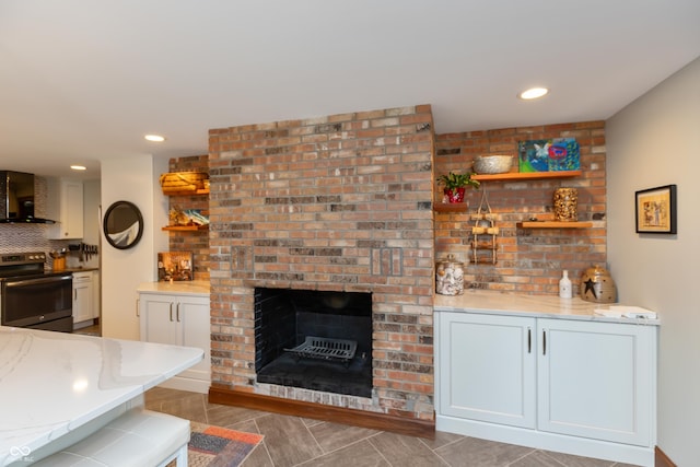 1541 Stadium Dr, Seymour, IN 47274 - living room with a brick fireplace, light tile patterned floors, and recessed lighting