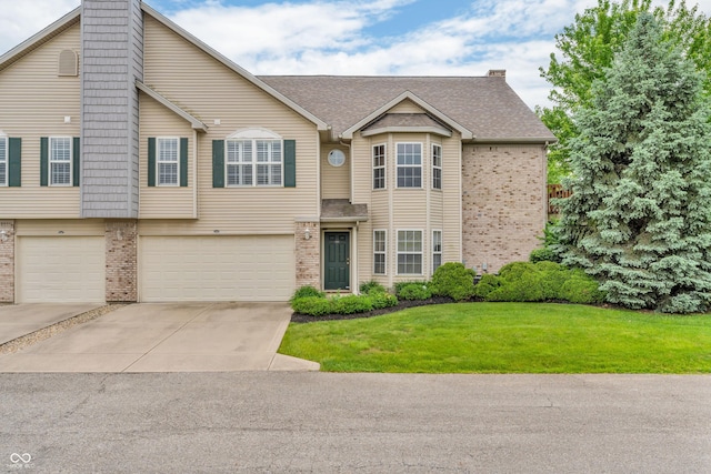1139 Fernwood Way, Plainfield, IN 46168 - view of front of home with brick siding, a chimney, driveway, a garage, and a front lawn