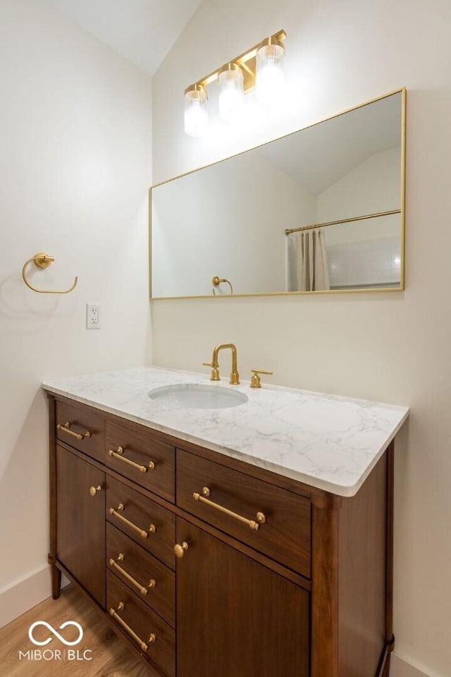 4251 Coventry Dr, Kokomo, IN 46902 - full bath featuring lofted ceiling, wood finished floors, vanity, and baseboards