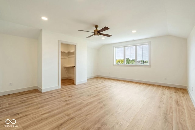 4251 Coventry Dr, Kokomo, IN 46902 - unfurnished bedroom featuring vaulted ceiling, light wood finished floors, baseboards, a walk in closet, and recessed lighting