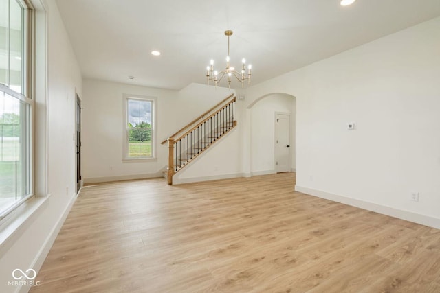 4251 Coventry Dr, Kokomo, IN 46902 - unfurnished living room featuring arched walkways, stairs, light wood finished floors, a chandelier, and recessed lighting