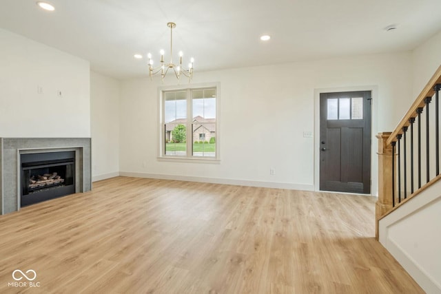 4251 Coventry Dr, Kokomo, IN 46902 - unfurnished living room featuring stairway, a chandelier, light wood-style floors, recessed lighting, and baseboards