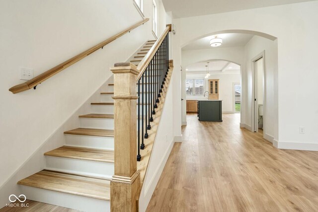 4251 Coventry Dr, Kokomo, IN 46902 - staircase with wood finished floors, arched walkways, and baseboards