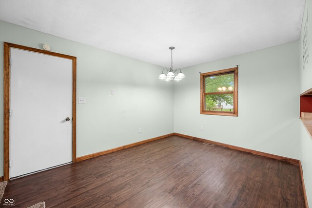 201 Hayden Pike, North Vernon, IN 47265 - unfurnished room with wood finished floors, a chandelier, baseboards, and a smoke detector