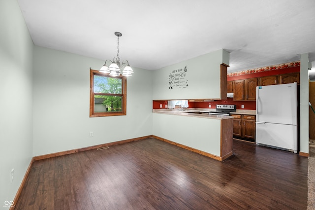201 Hayden Pike, North Vernon, IN 47265 - kitchen with freestanding refrigerator, electric stove, dark wood-style flooring, and a peninsula
