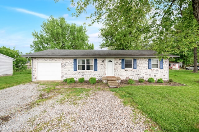 201 Hayden Pike, North Vernon, IN 47265 - single story home with gravel driveway, a garage, brick siding, and a front yard
