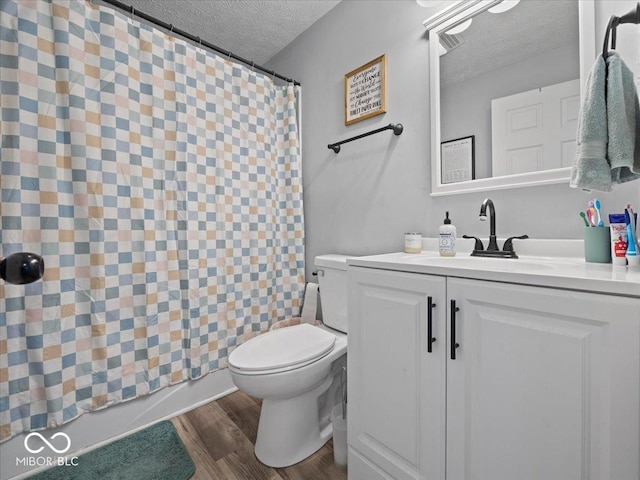 547 W Taylor St, Shelbyville, IN 46176 - bathroom with a textured ceiling, toilet, a shower with curtain, wood finished floors, and vanity