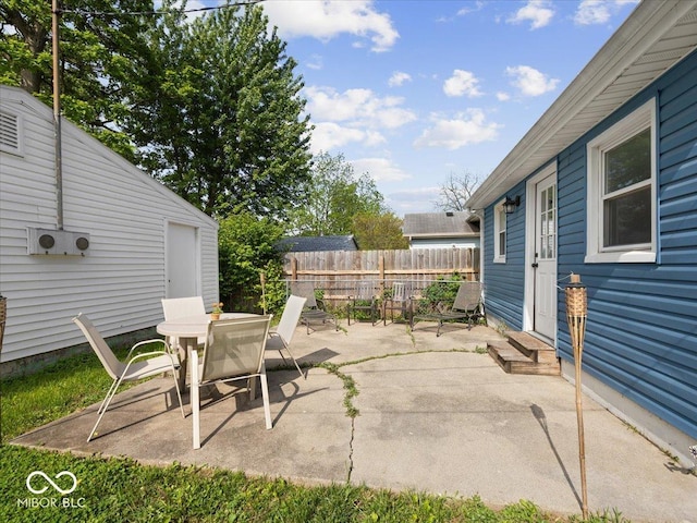 547 W Taylor St, Shelbyville, IN 46176 - view of patio with fence, outdoor dining area, and entry steps