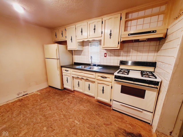 704 E Perry St, Indianapolis, IN 46227 - kitchen with white appliances, a sink, dark countertops, tasteful backsplash, and a textured ceiling