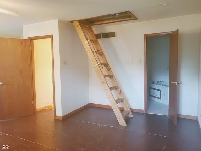 704 E Perry St, Indianapolis, IN 46227 - unfurnished bedroom with baseboards and concrete flooring