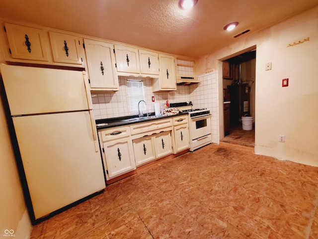 704 E Perry St, Indianapolis, IN 46227 - kitchen featuring white appliances, a sink, dark countertops, water heater, and under cabinet range hood