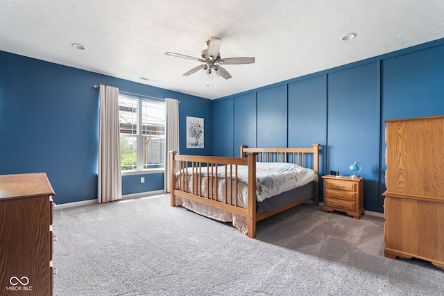 4659 W Otway Ln, New Palestine, IN 46163 - bedroom with carpet flooring, a textured ceiling, a decorative wall, a ceiling fan, and baseboards
