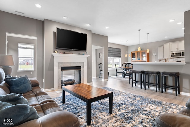 4659 W Otway Ln, New Palestine, IN 46163 - living area featuring recessed lighting, light wood finished floors, baseboards, and a fireplace