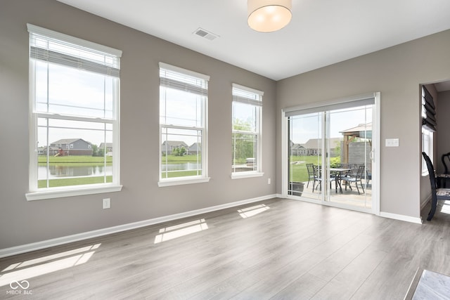 4659 W Otway Ln, New Palestine, IN 46163 - spare room with wood finished floors, baseboards, and a water view