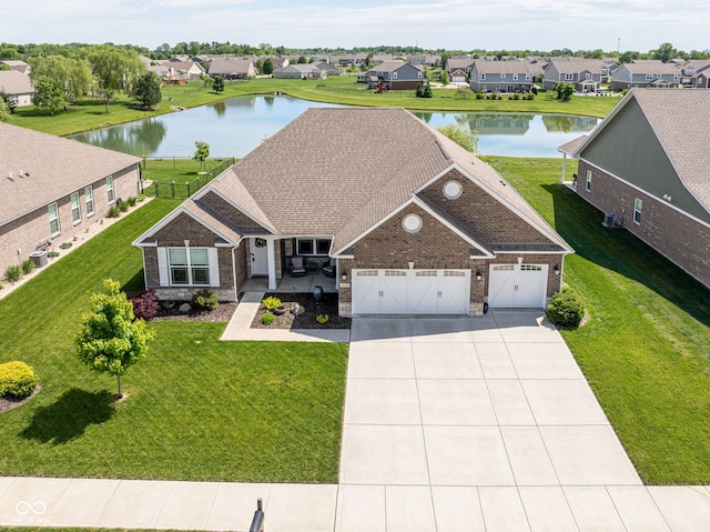 4659 W Otway Ln, New Palestine, IN 46163 - view of front facade featuring brick siding, a water view, driveway, and a garage