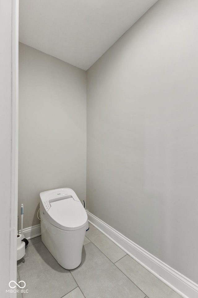 6230 E 56th St, Indianapolis, IN 46226 - bathroom with baseboards, tile patterned floors, and toilet